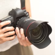 private investigator performing surveillance with camera